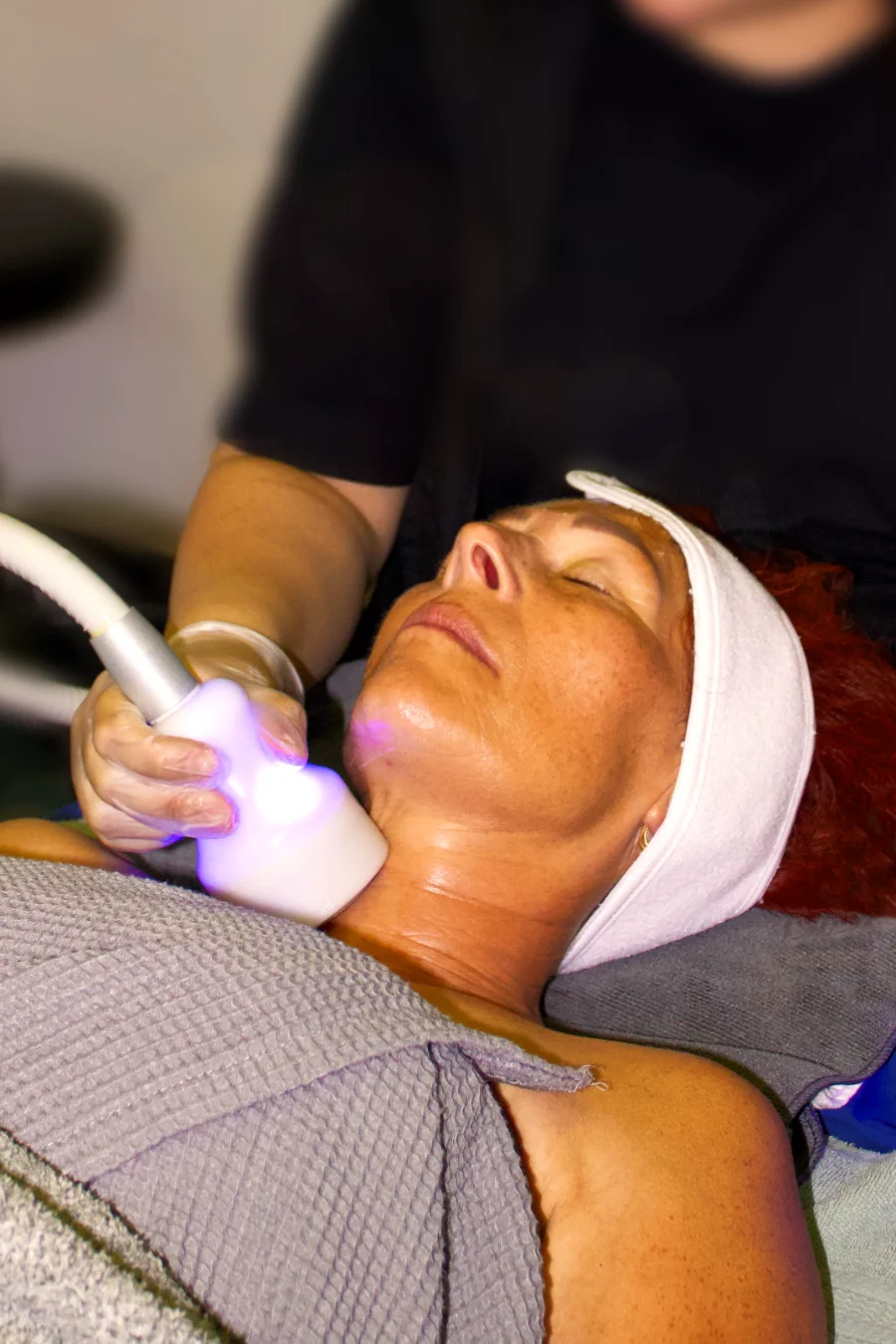 A person receiving a cryo facial treatment